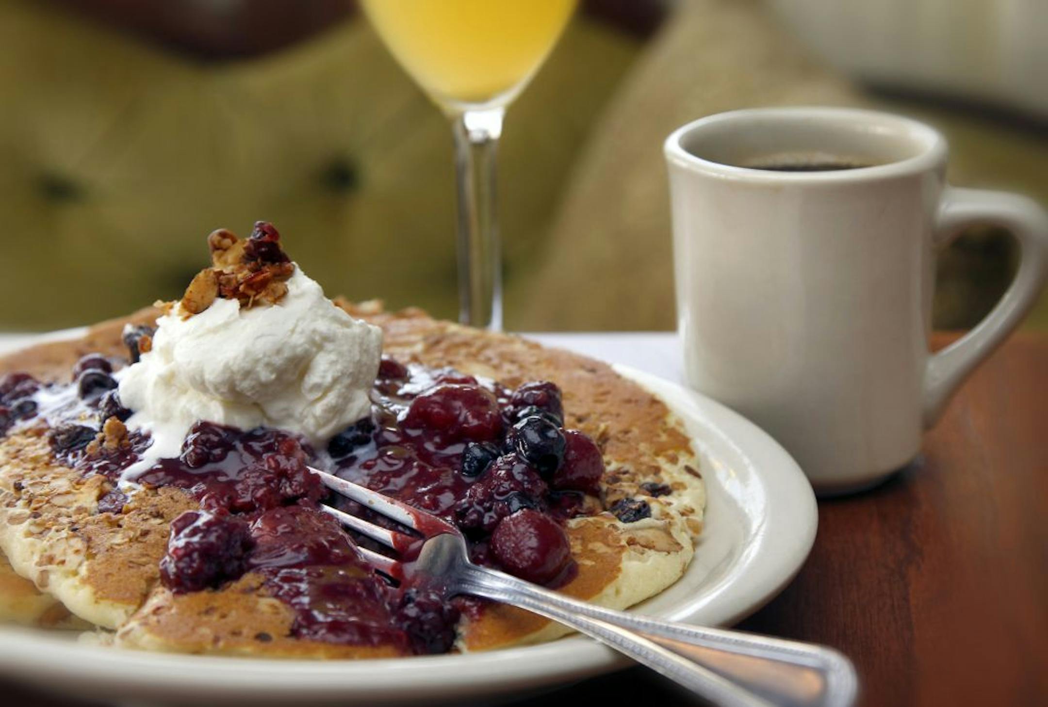 Hazel's, Granola infused cakes with a mixed berry compote, "Hippy pancakes" are a big hit in the Northeast neighborhood according the owners, Brothers, Andrew and Adam Sieve
