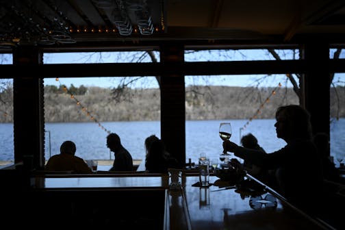 Carol Van Valkenburg of Stillwater sipped wine while eating lunch at the bar of the Dock Cafe in Stillwater on Wednesday.