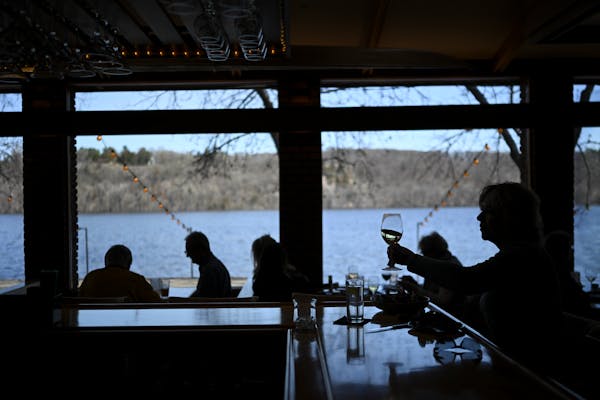 Carol Van Valkenburg of Stillwater sipped wine while eating lunch at the bar of the Dock Cafe in Stillwater on Wednesday.