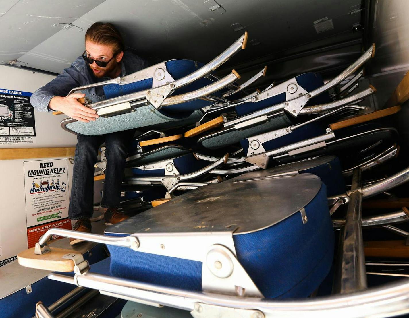 Andy Smith unloaded theater chairs he purchased in Boston for his new microcinema, Gray Duck Theater, in Rochester. The 66-seat theater opened Friday.