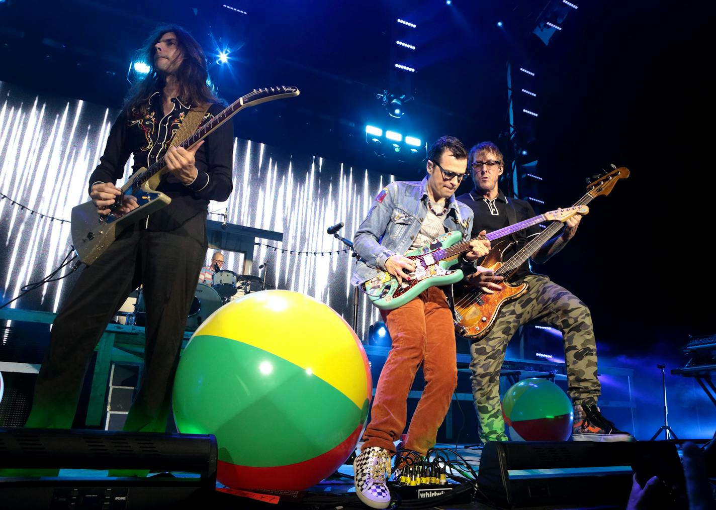 Brian Bell, from left, Rivers Cuomo and Scott Shriner of the band Weezer perform in concert at the BB&T Pavilion on Tuesday, July 5, 2016, in Camden, N.J. (Photo by Owen Sweeney/Invision/AP)