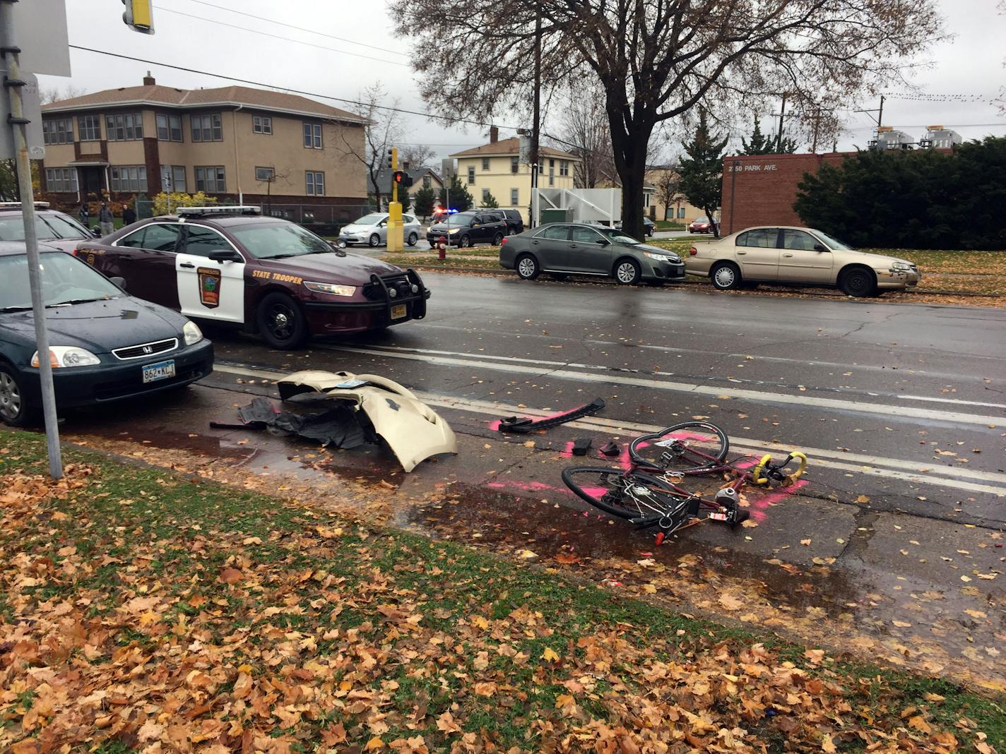 A mangled bicycle and car parts are left on the ground at Park Avenue South and 28th Street after a police incident on Friday morning.