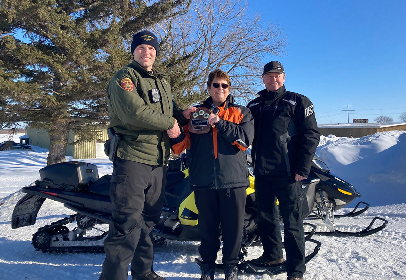 Sonya and Earl Anderson were named Snowmobile Instructors of the Year by the Department of Natural Resources. They're shown with conservation officer Mitch Lawler, left.