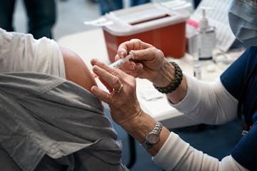 Sgt. Heath Bird of Plymouth P.D. received his COVID-19 Moderna vaccine from RN Gloria Christensen.