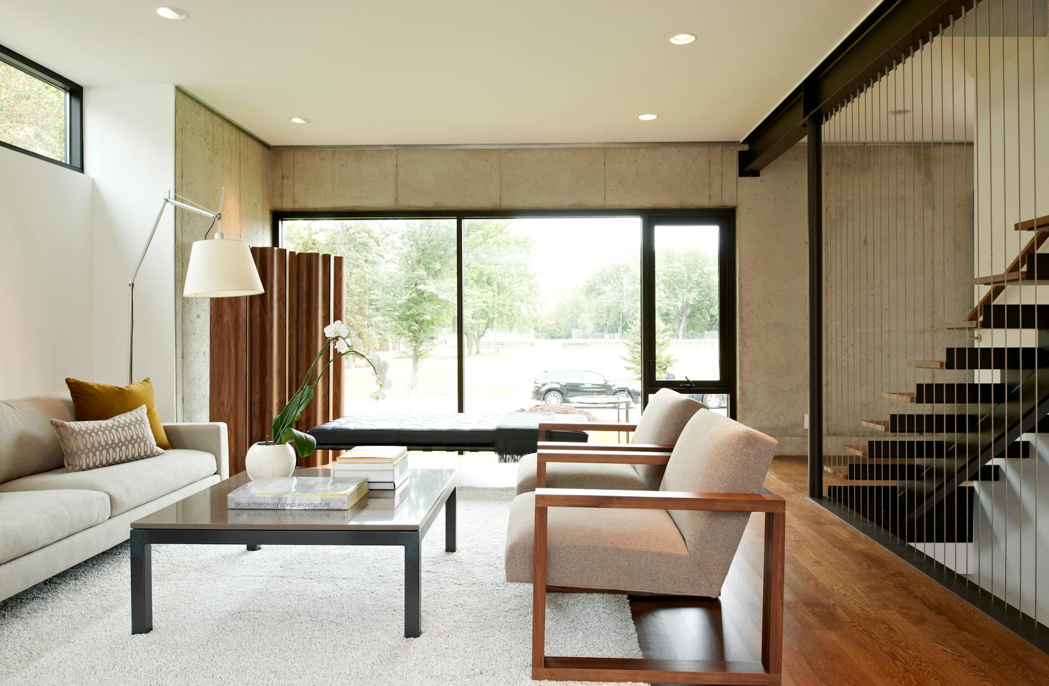 ABOVE: The living room’s aluminum commercial storefront window faces the park across the street; high clerestory windows let in light but offer privacy. BELOW: The front entry of the home.