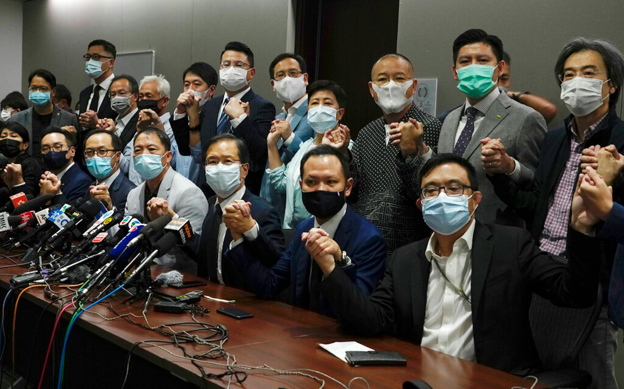 Hong Kong's pro-democracy legislators pose for a photo before a press conference at Legislative Council in Hong Kong, Wednesday, Nov. 11, 2020.
