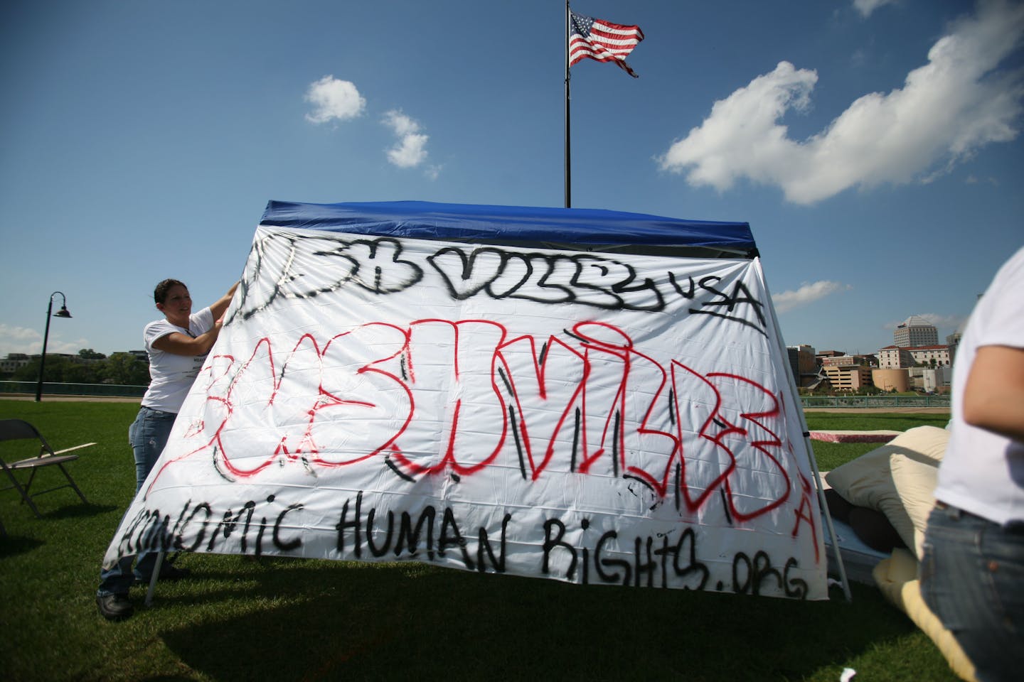 Group members put up signs to mark their encampment.