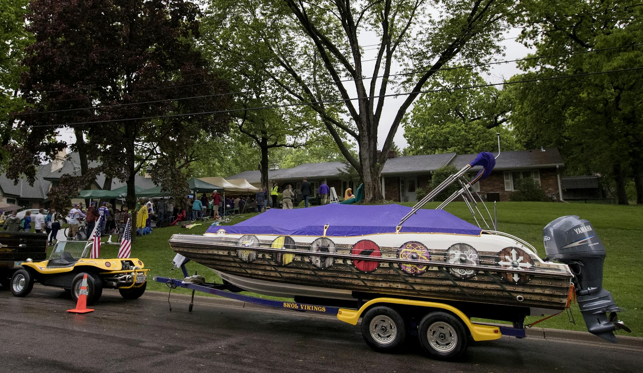 A dune buggy and a boat for sale at the Bud Grant annual garage sale.