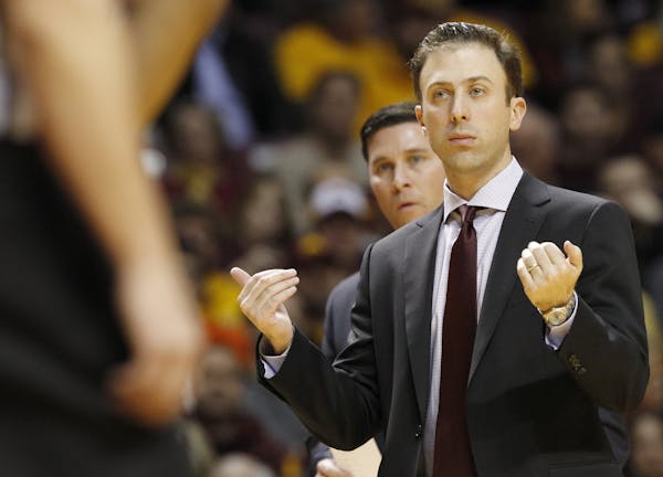 Minnesota head coach Richard Pitino gestures to his players during the first half of an NCAA college basketball game against Illinois in Minneapolis, 