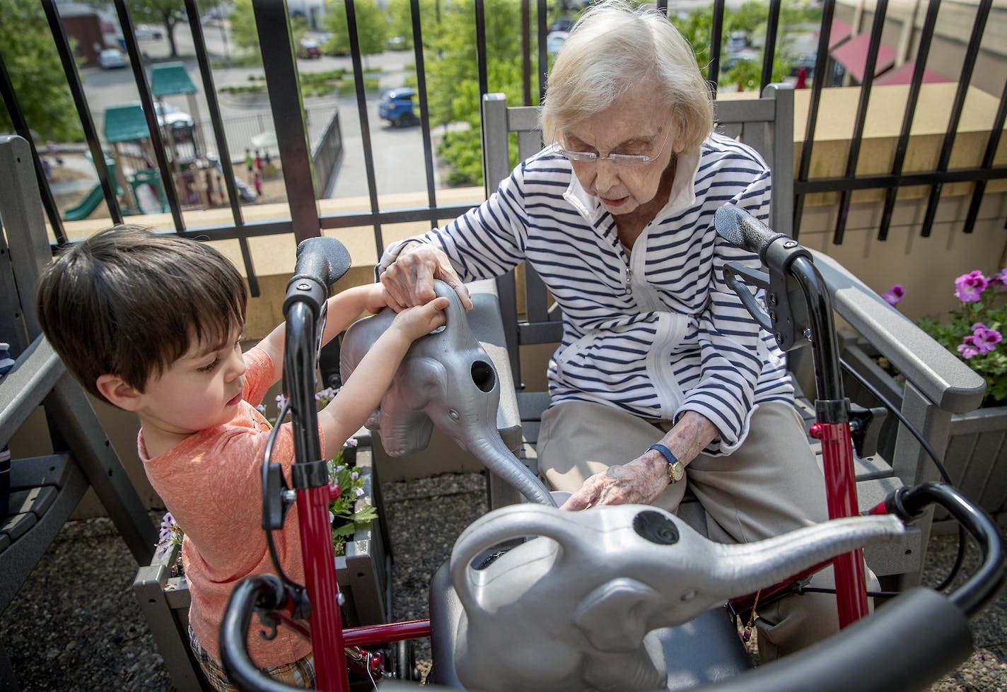 Logan Clifford, right, from the TowerLight Child Care Center helped Evelyn Thoreson, from the TowerLight Memory Care Unit, water plants as part of their multigenerational program, Friday, May 31, 2019. ] ELIZABETH FLORES &#x2022; liz.flores@startribune.com