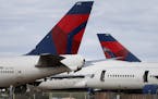 Mothballed Delta Air Lines passenger planes are joined by recently arrived Delta airplanes at Pinal Airpark Wednesday, March 18, 2020, in Red Rock, Ar