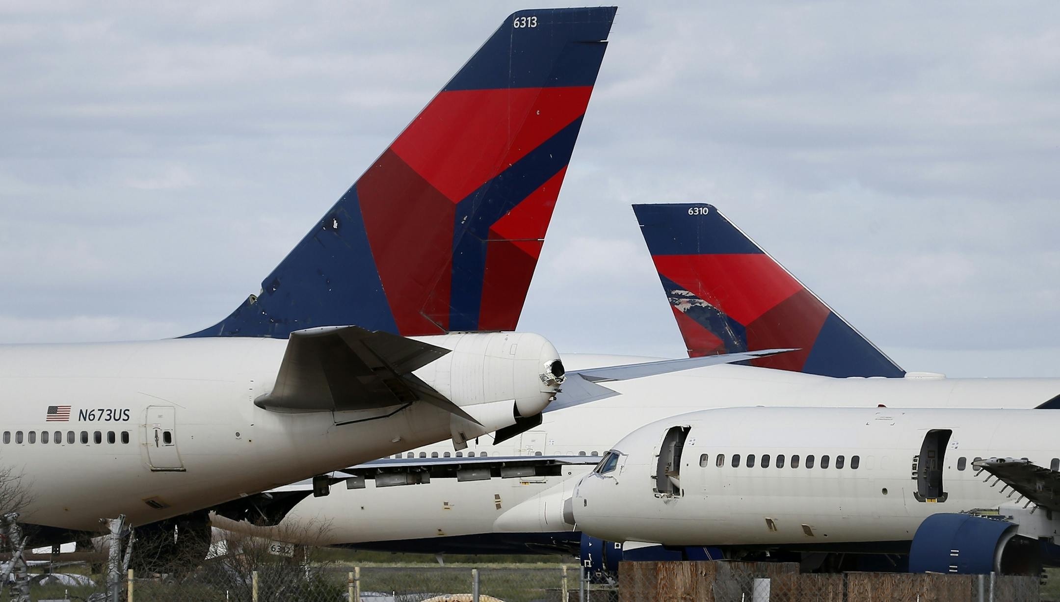 Mothballed Delta Air Lines passenger planes are joined by recently arrived Delta airplanes at Pinal Airpark Wednesday, March 18, 2020, in Red Rock, Ariz., as many passenger planes are being kept at the facility as airlines cut back on service due to the coronavirus COVID-19 pandemic. (AP Photo/Ross D. Franklin)