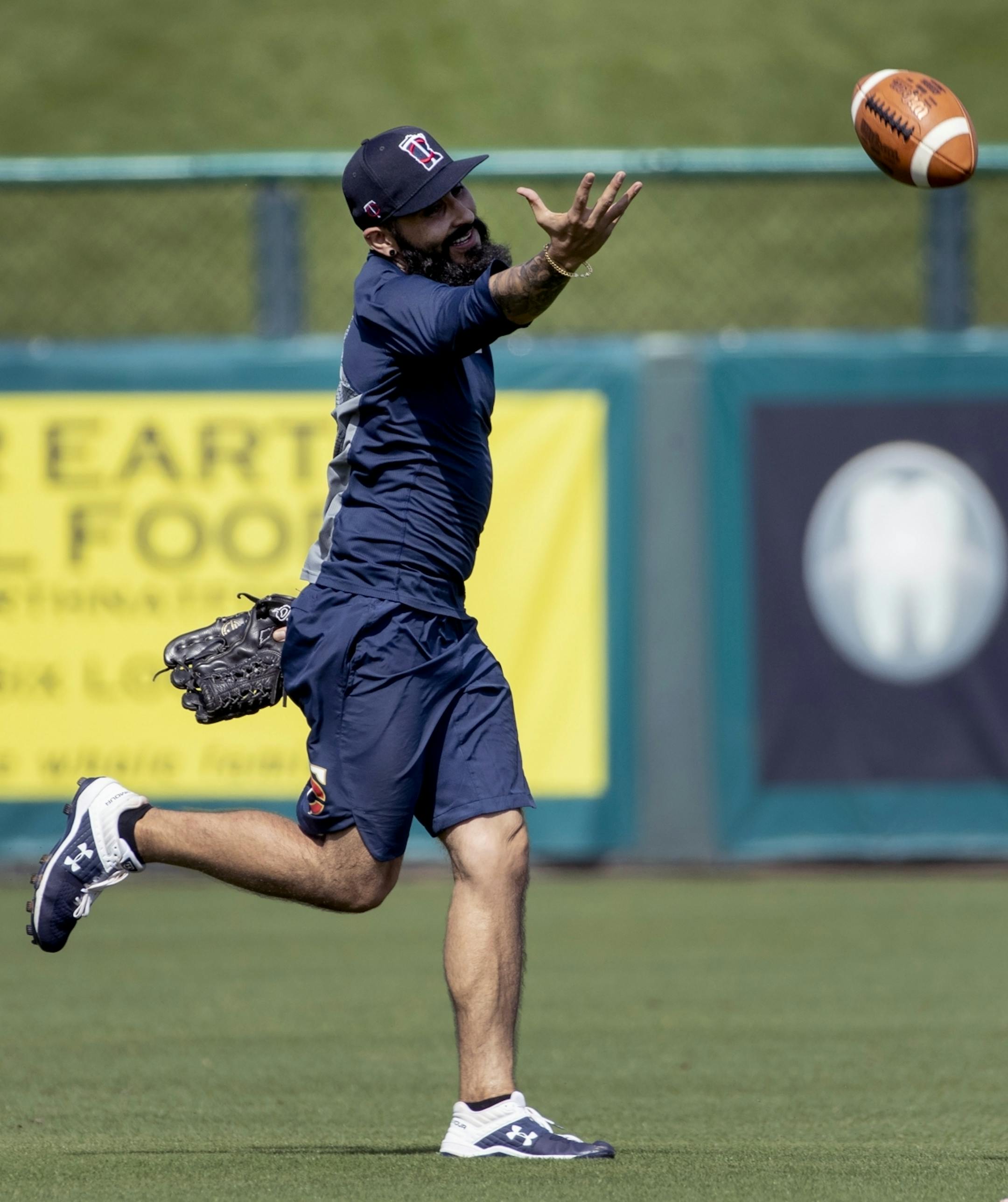 Minnesota Twins pitcher Sergio Romo attempted to catch a football during practice on Tuesday.