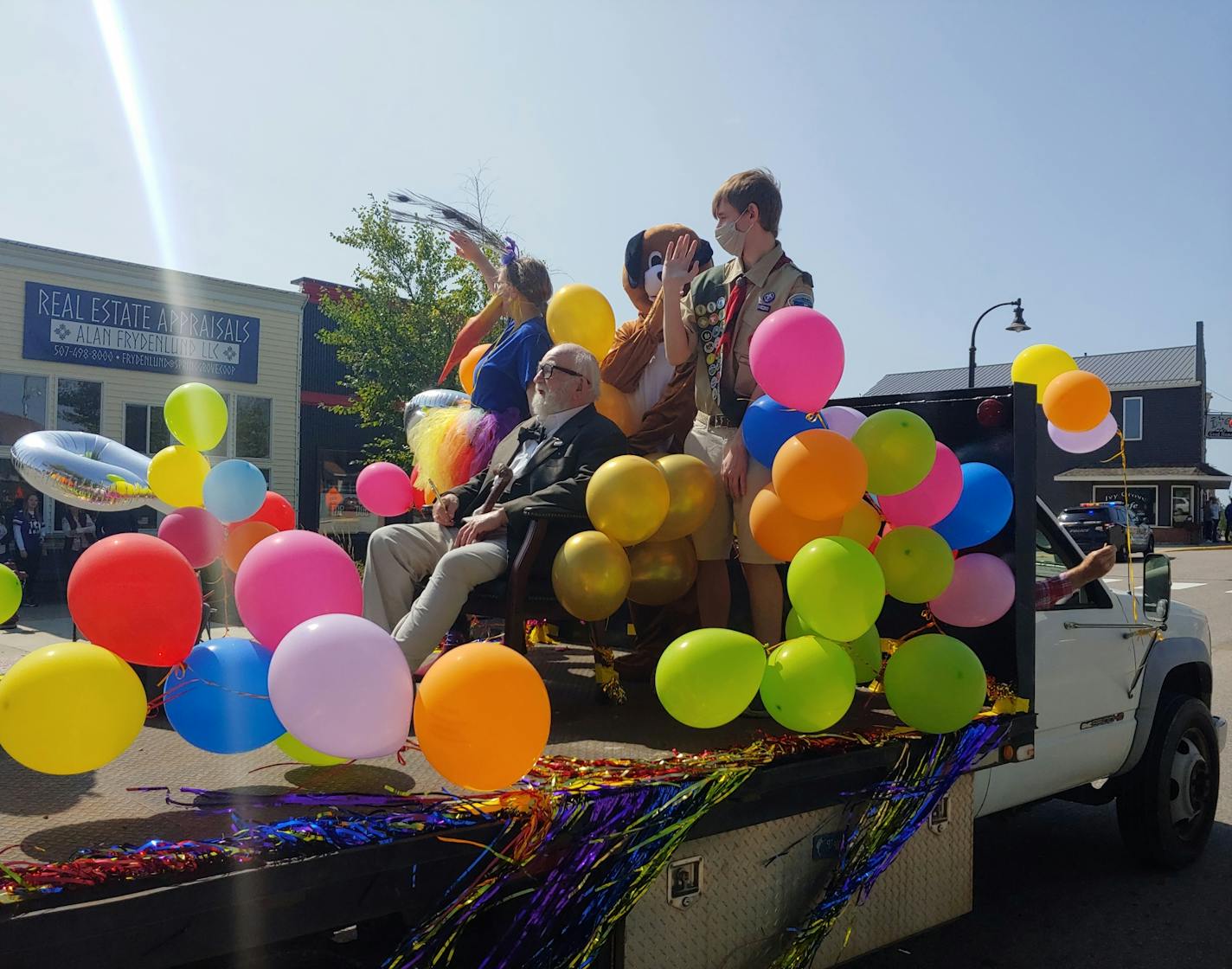 Ed Asner, surrounded by Spring Grove locals dressed as "Up" characters, relishes his role Sunday as special guest in the town's parade.