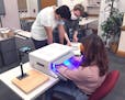 Kushal Sehgal, James Kerber and Emily Wagner work on a phototherapy device  treat or even prevent Reynaud’s symptoms, developed at the University of