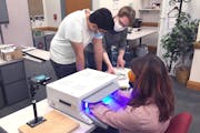 Kushal Sehgal, James Kerber and Emily Wagner work on a phototherapy device  treat or even prevent Reynaud’s symptoms, developed at the University of