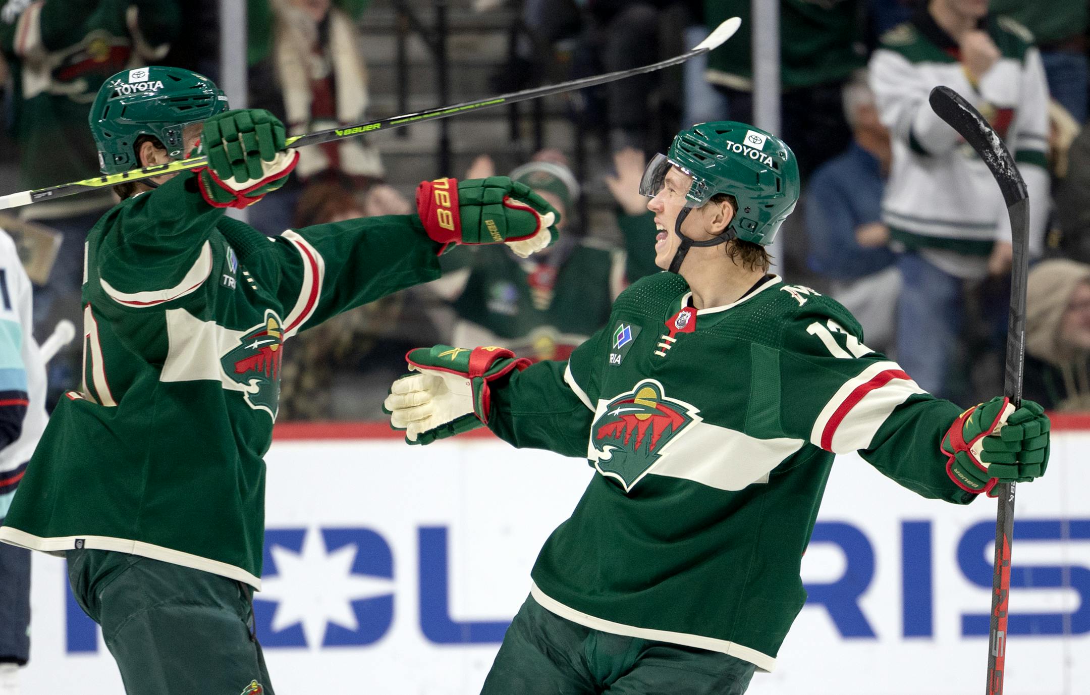 Matt Boldy (12) of the Minnesota Wild celebrates with Marcus Johansson (90) after scoring a goal in the second period.
