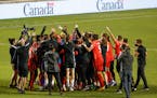 Canada celebrates a 3-0 win over Haiti in a World Cup qualifying soccer match, Tuesday, June 15, 2021, in Bridgeview, Ill. (AP Photo/Kamil Krzaczynski
