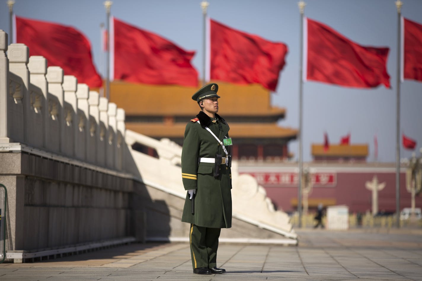 A Chinese paramilitary policeman stands on duty on Tiananmen Square before delegates arrive for the opening session of the Chinese People's Political Consultative Conference in Beijing's Great Hall of the People, Tuesday, March 3, 2015. The more than 2,000 members of China's top legislative advisory body convened their annual meeting Tuesday, kicking off a political high season that will continue with the opening of the national congress later in the week.