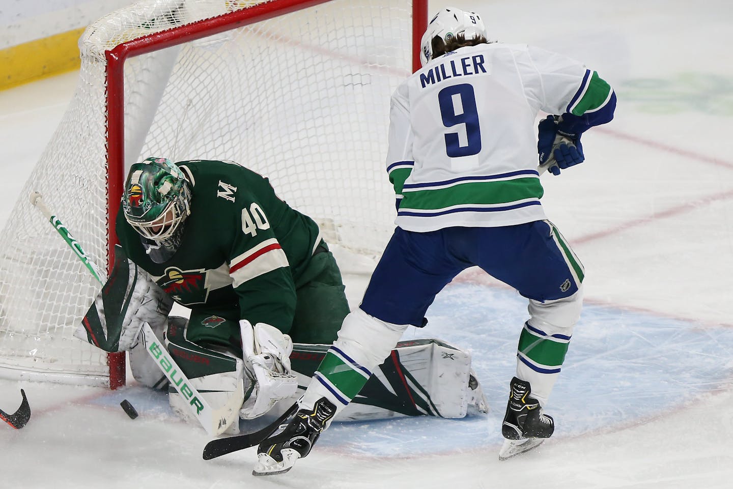 Vancouver Canucks' J.T. Miller tries to score a goal as Minnesota Wild's goalie Devan Dubnyk blocks the net in the first period of an NHL hockey game Sunday, Jan. 12, 2020, in St. Paul, Minn. Vancouver won 4-1. (AP Photo/Stacy Bengs)