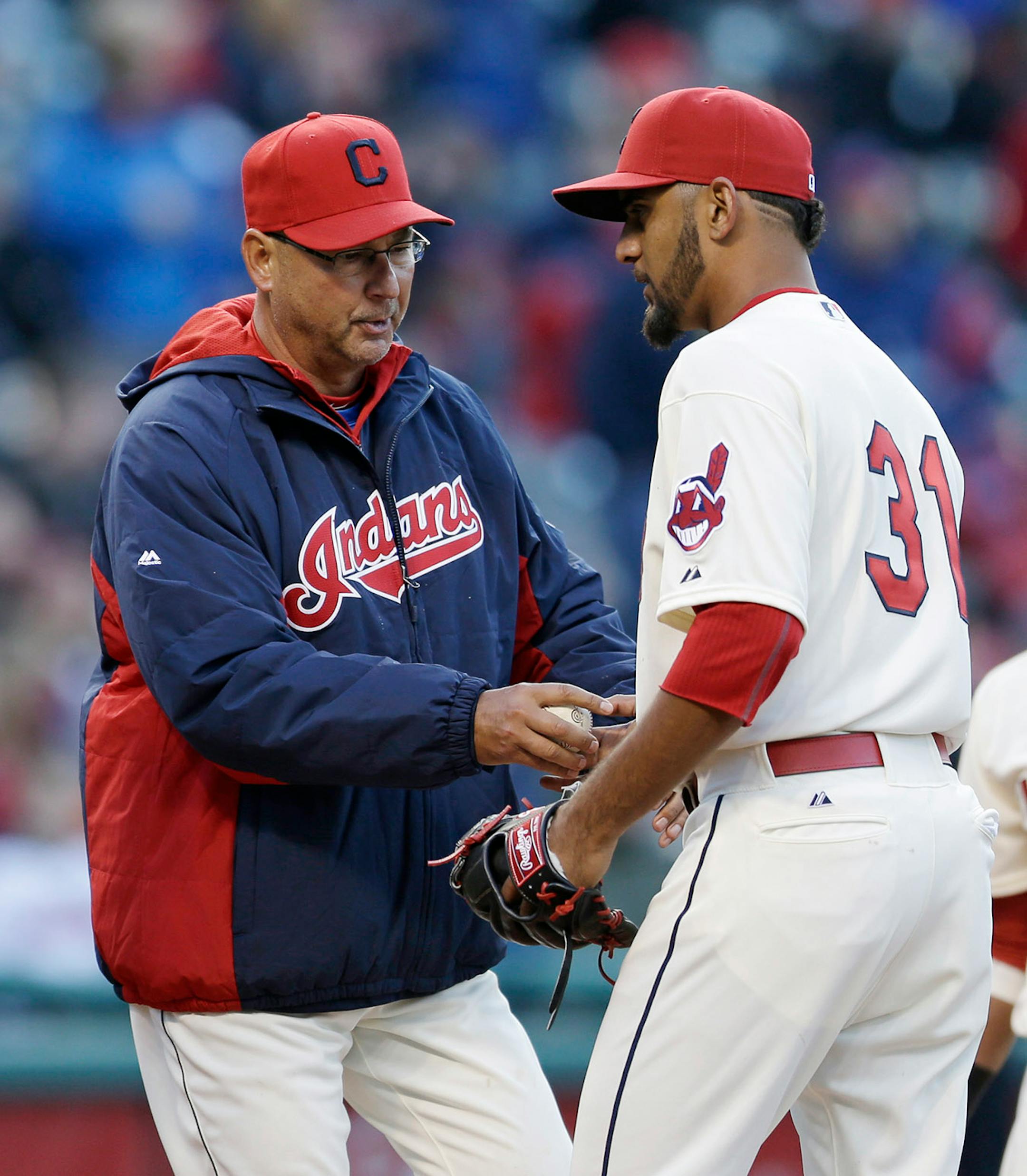 Cleveland Indians manager Terry Francona, left, grabs the ball from starting pitcher Danny Salazar in the sixth inning of a baseball game against the Minnesota Twins, Friday, April 4, 2014, in Cleveland. (AP Photo/Tony Dejak)