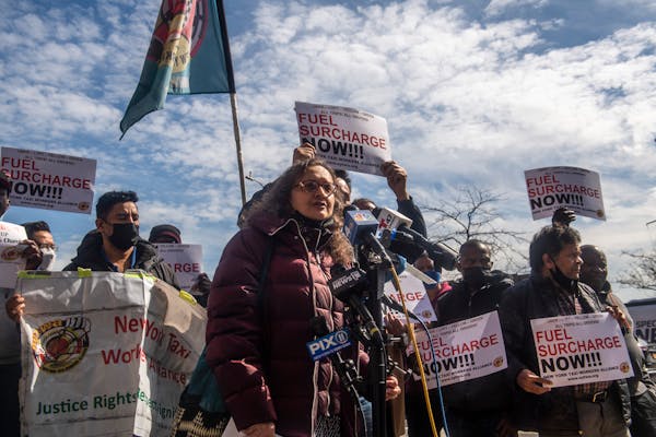 Bhairavi Desai, director of New York taxi workers alliance, speaks at a rally calling for surcharges on fuel at the Shell gas station on Friday, March