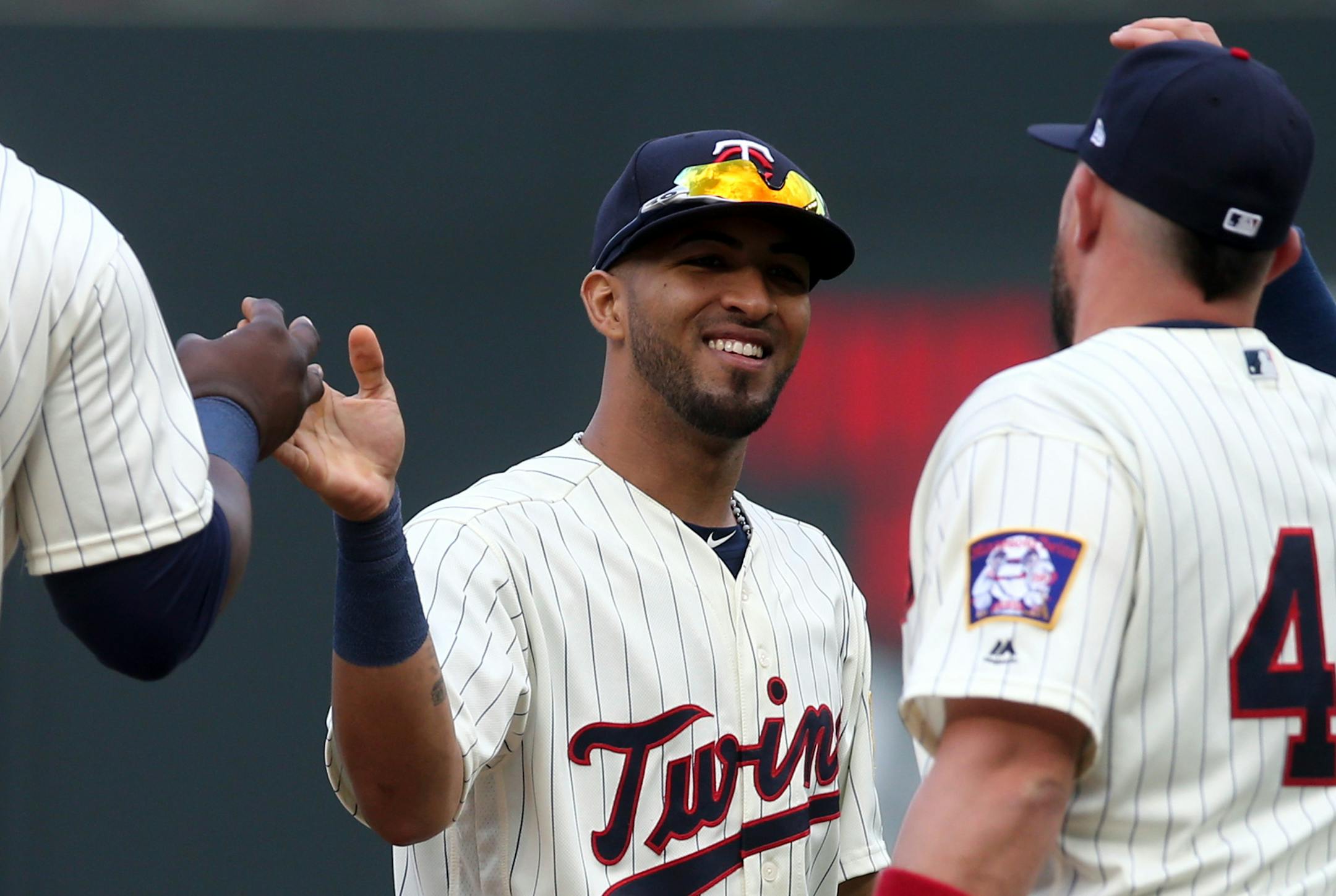 Minnesota Twins' Eddie Rosario, center, goes through the celebration line after the Twins defeated the Cleveland Indians 7-1 in a baseball game Saturday, June 2, 2018, in Minneapolis. (AP Photo/Jim Mone)