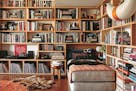 A reading nook in the Los Angeles home of Roman Alonso is layered and colorful, with a daybed, records, pottery and books. Nina Freudenberger's book "