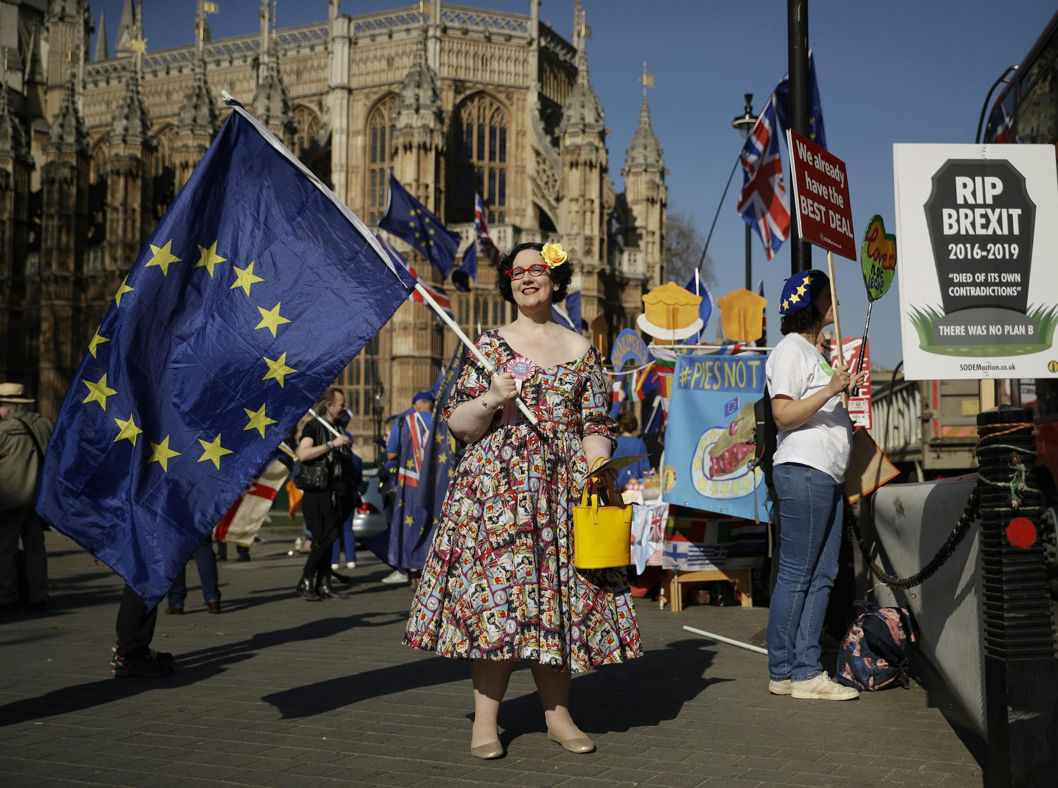 A remain in the European Union supporter protests across the street from the Houses of Parliament in London, Wednesday, Feb. 27, 2019. British Prime Minister Theresa May says she will give British lawmakers a choice of approving her divorce agreement, leaving the EU March 29 without a deal or asking to delay Brexit by up to three months. (AP Photo/Matt Dunham) ORG XMIT: LMD108