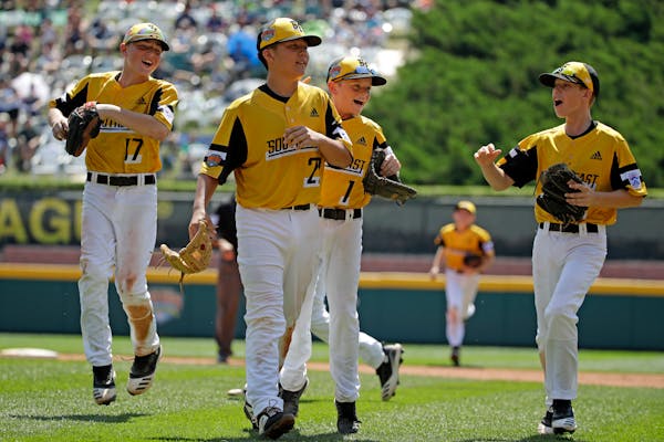 South Riding, Virginia pitcher Justin Lee (22) celebrates as he walks off the field with Chase Obstgarten, left, Matt Coleman (1), and Colton Hicks (9