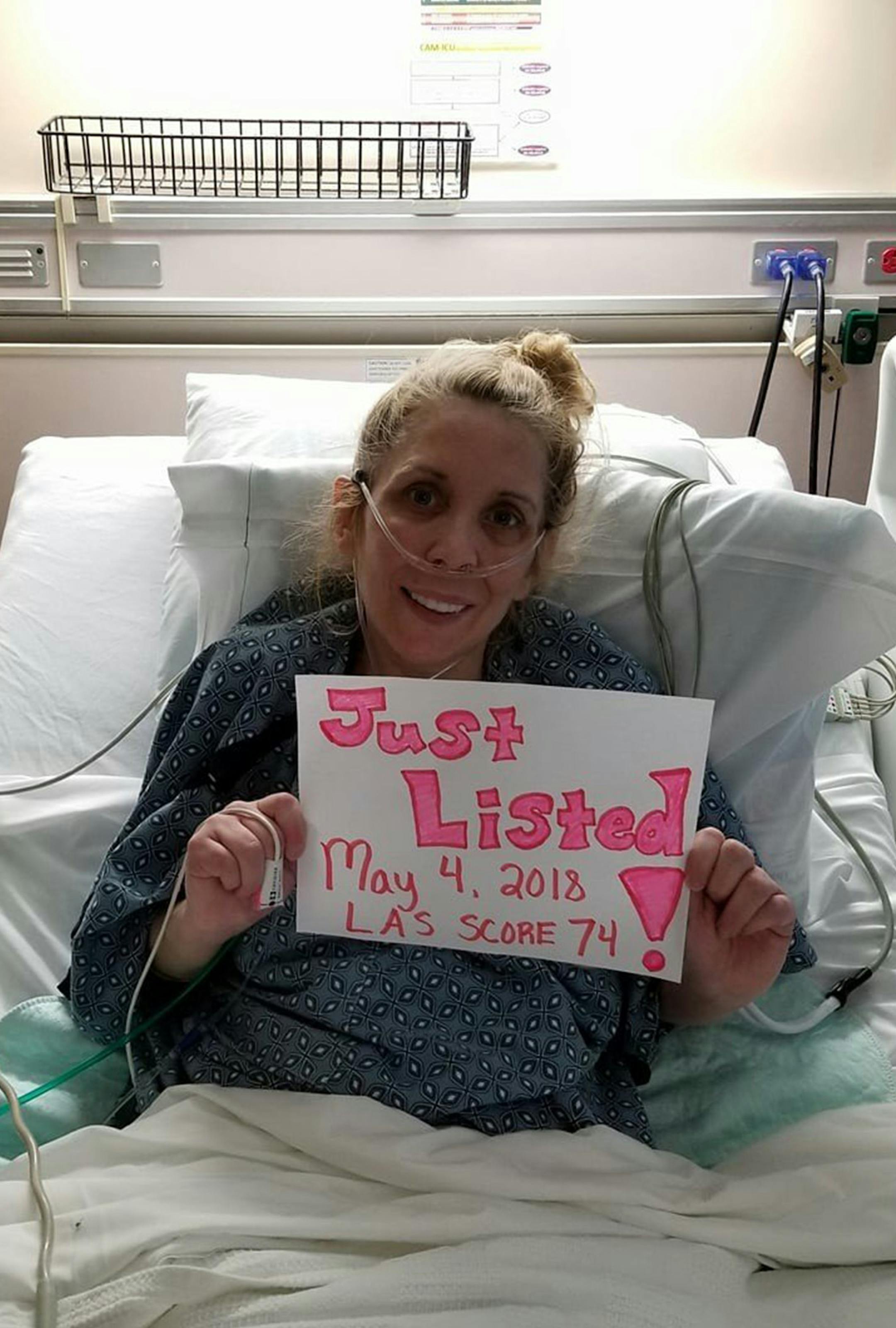 Kelly Asbell, 40, of Valparaiso, holds a sign May 4 announcing she has been placed on a transplant list for double lung surgery. She underwent the transplant May 18 at Loyola University Medical Center in Chicago. (Courtesy of Kelly Asbell)