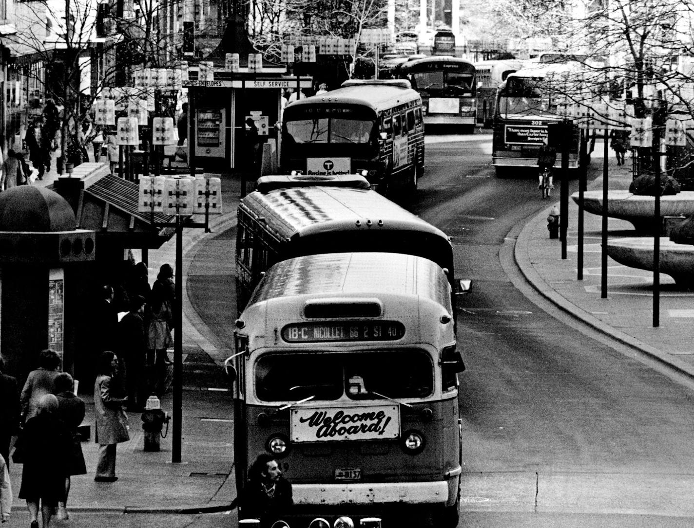 April 22, 1974 Buses wind along Nicollet Mall as far as the eye can see at rush hour. View is north from Dayton's-IDS skyway. Stand long enough in the bus fumes that sweep along Nicollet Mall at rush hour and you begin to wonder when the taped background music will broadcast "Smoke Gets in Your Eyes." The "5 o'clock fumes," as one rider calls them, are just a by-product of steady increases in rush-hour bus traffic in down-town Minneapolis. But one measure to deal with that congestion - experimen