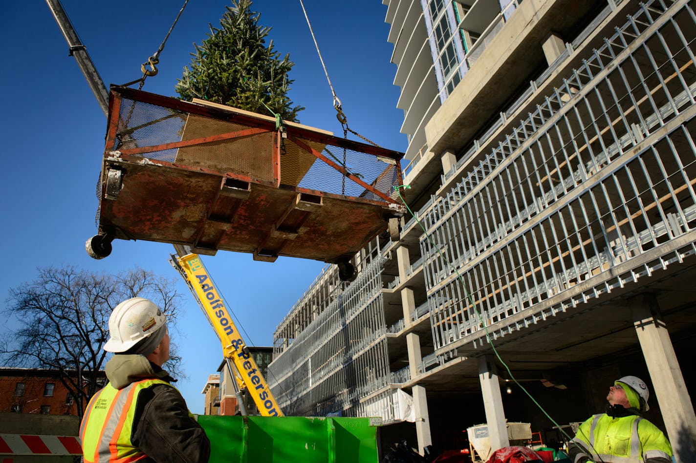 A Christmas tree was raised to the top of LPM Apartments, a 36-story apartment building being built in Loring Park. The tree is raised to the top of a new building signifying the completion of the building's structure. Tuesday, December 10, 2013 ] GLEN STUBBE * gstubbe@startribune.com