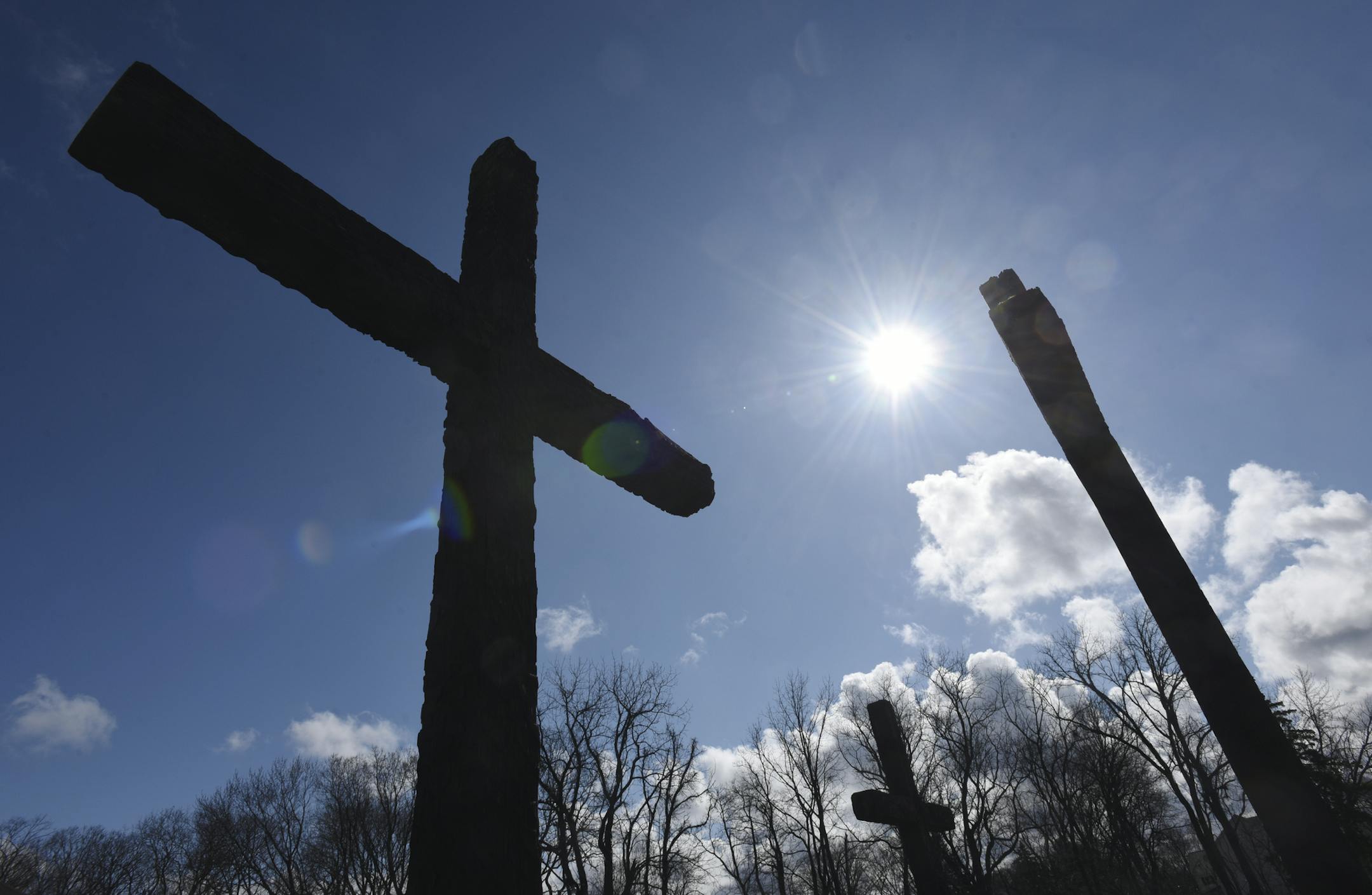 The sun shines upon a trio of crosses outside of Riverview Park Christian Church in St. Joseph, Mich., on Friday, April 10, 2020. As Easter Sunday approaches, churches across the country are facing restrictions, due to the COVID-19 pandemic, forcing many to hold virtual services online.(Don Campbell/The Herald-Palladium via AP)