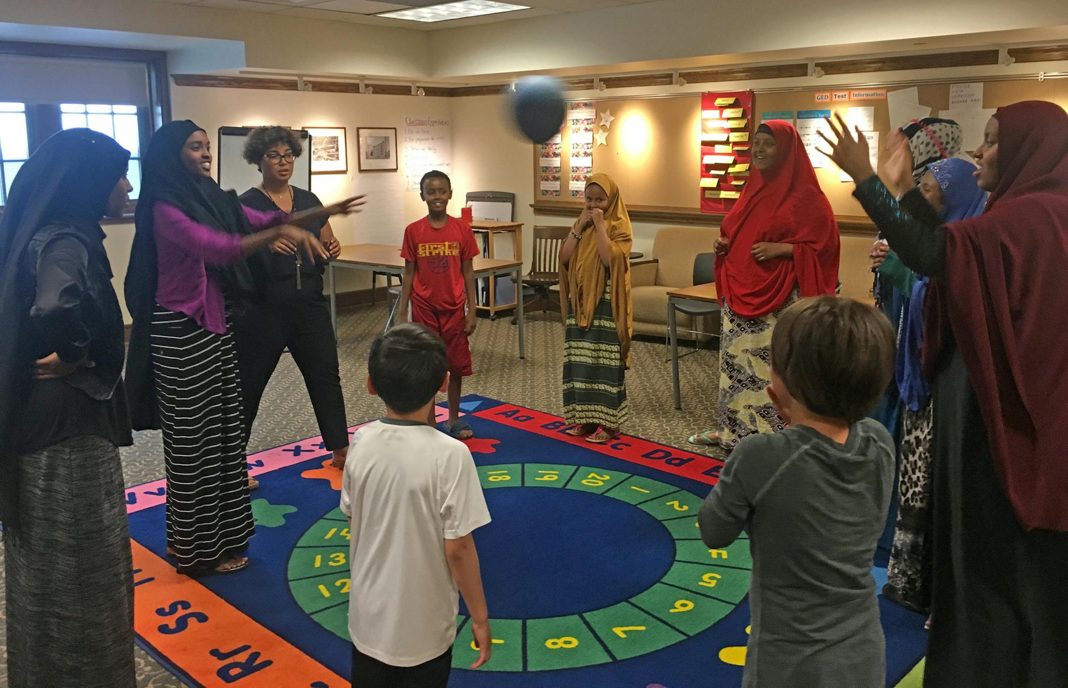 Tiffany Casey (third from left) leads a group of students in a word association game during book club at the Sumner Library in Minneapolis. ] Sarah Jarvis - Star Tribune 7/14/17