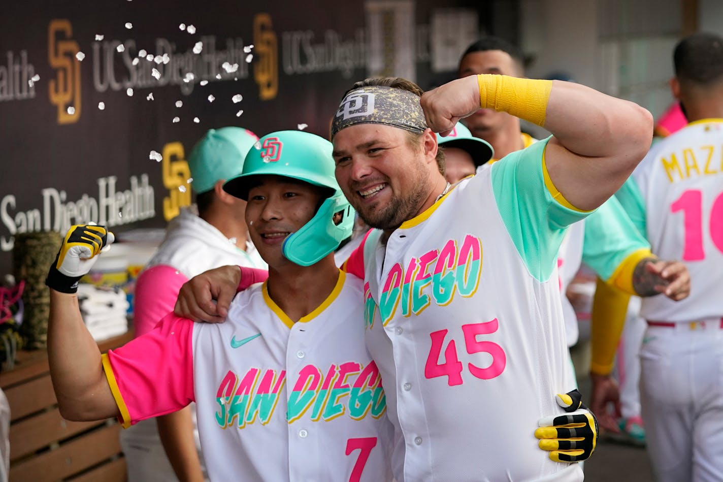 San Diego Padres' Ha-Seong Kim, left, celebrates with teammate Luke Voit (45) after hitting a home run during the second inning of a baseball game against the Minnesota Twins, Friday, July 29, 2022, in San Diego. (AP Photo/Gregory Bull)