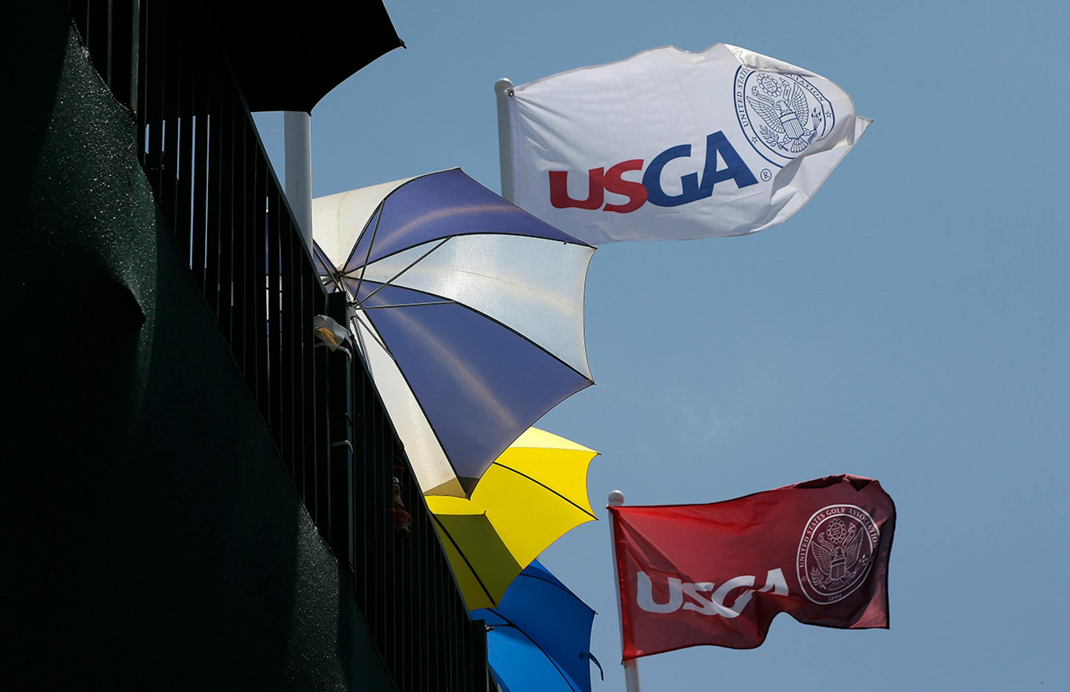 Fans wait for players to arrives at the 18th hole during the third round of the U.S. Open golf tournament in Pinehurst, N.C., Saturday, June 14, 2014. (AP Photo/Charlie Riedel)