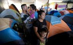 Gustavo Loza and his wife, Leidy Rivas, arrived in Tijuana after traveling for more than a month from El Salvador. The couple arrived with their two c