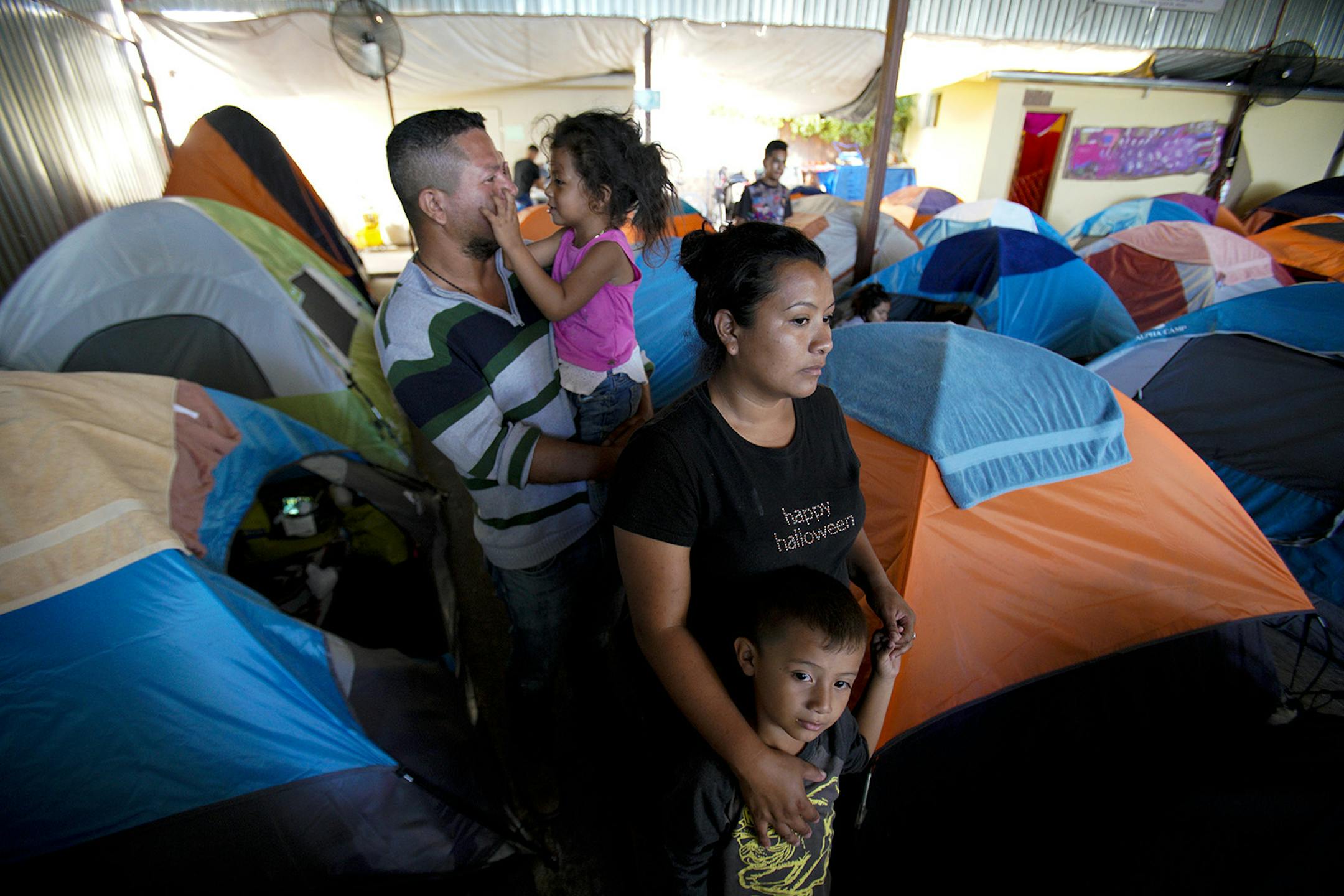 Gustavo Loza and his wife, Leidy Rivas, arrived in Tijuana after traveling for more than a month from El Salvador. The couple arrived with their two children, Katerine, 4, and Hamilton, 5, and are waiting to see if they can stay at the Movimiento Juventud shelter. (Nelvin C. Cepeda/San Diego Union-Tribune/TNS)