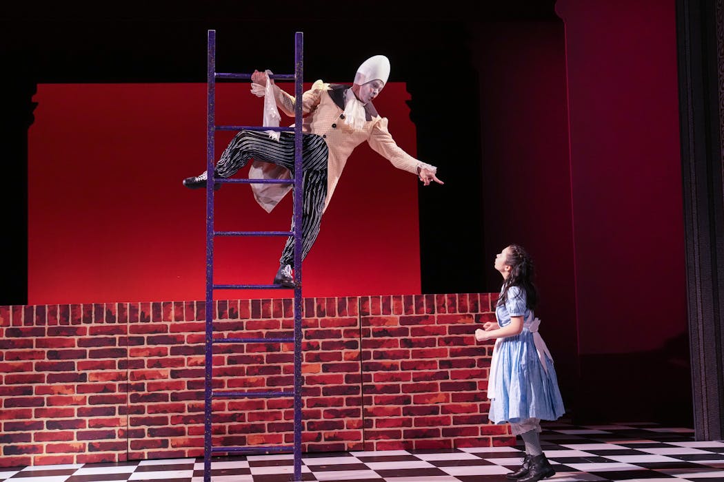 Dean Holt is Humpty Dumpty and Audrey Mojica plays Alice in the Children’s Theatre Company’s “Alice in Wonderland.” 
