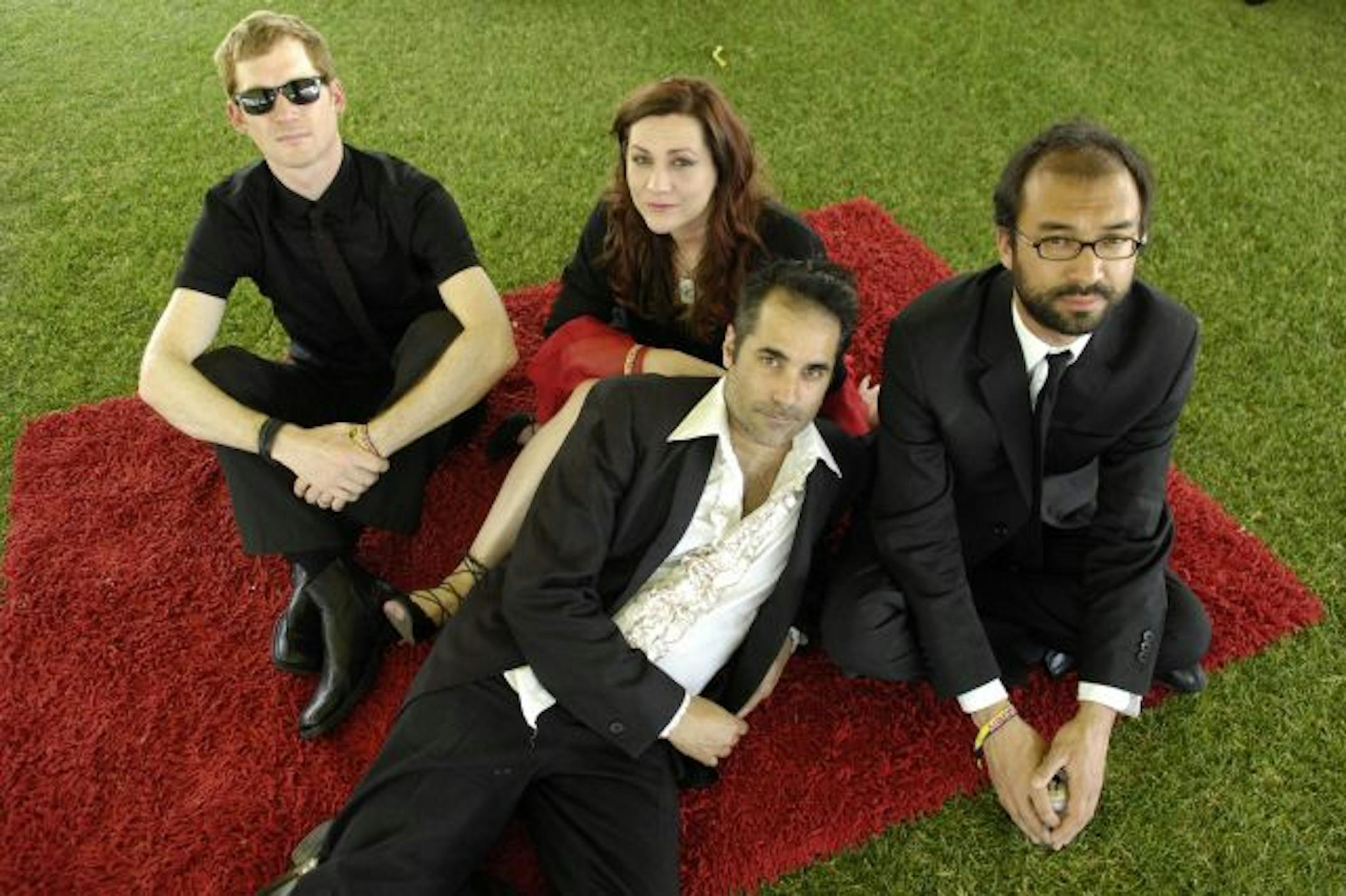 DeVotchKa band members, from left, Shawn King, Jeanie Shroder, Nick Urata and Tom Hagerman pose backstage at the Coachella Valley Music and Arts Festival in Indio, Calif., Saturday, April 26, 2008.