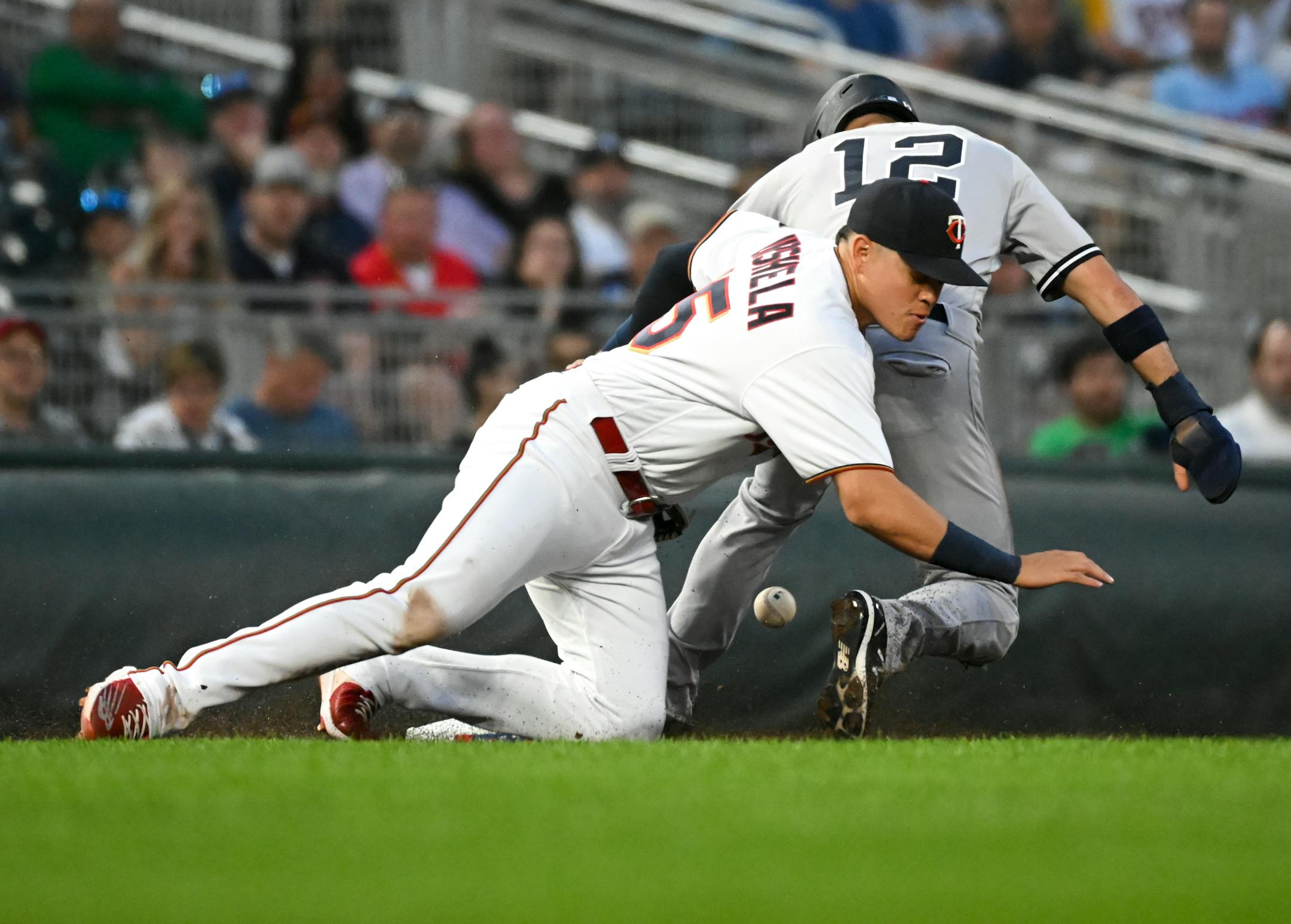 Minnesota Twins third baseman Gio Urshela (15) drops the ball as New York Yankees shortstop Isiah Kiner-Falefa (12) steals third base in the top of the sixth inning.