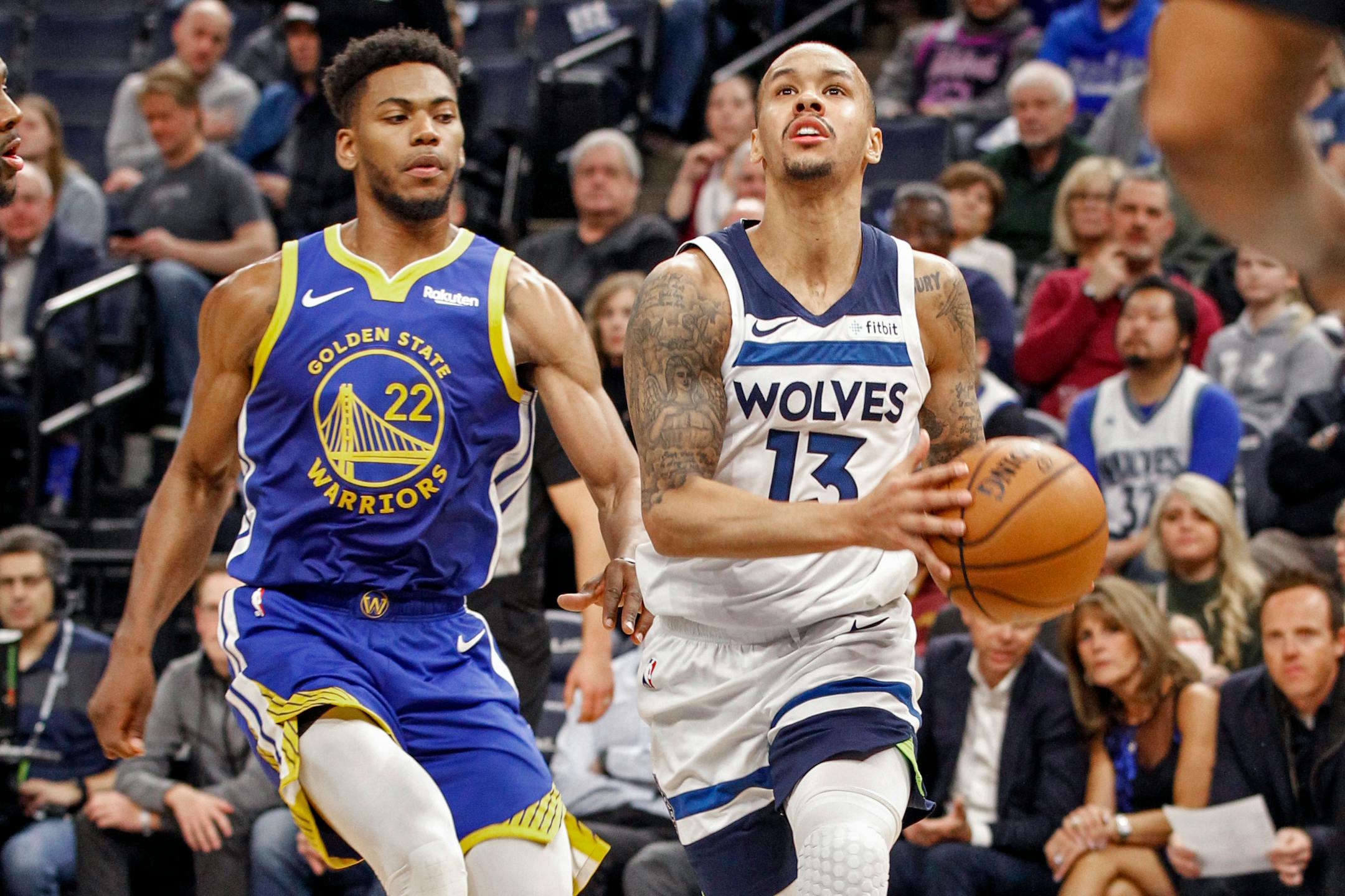 Minnesota Timberwolves guard Shabazz Napier (13) drives to the basket past Golden State Warriors forward Glenn Robinson III (22) in the first half of an NBA basketball game Thursday, Jan. 2, 2020, in Minneapolis. The Timberwolves won 99-84. (AP Photo/Bruce Kluckhohn)