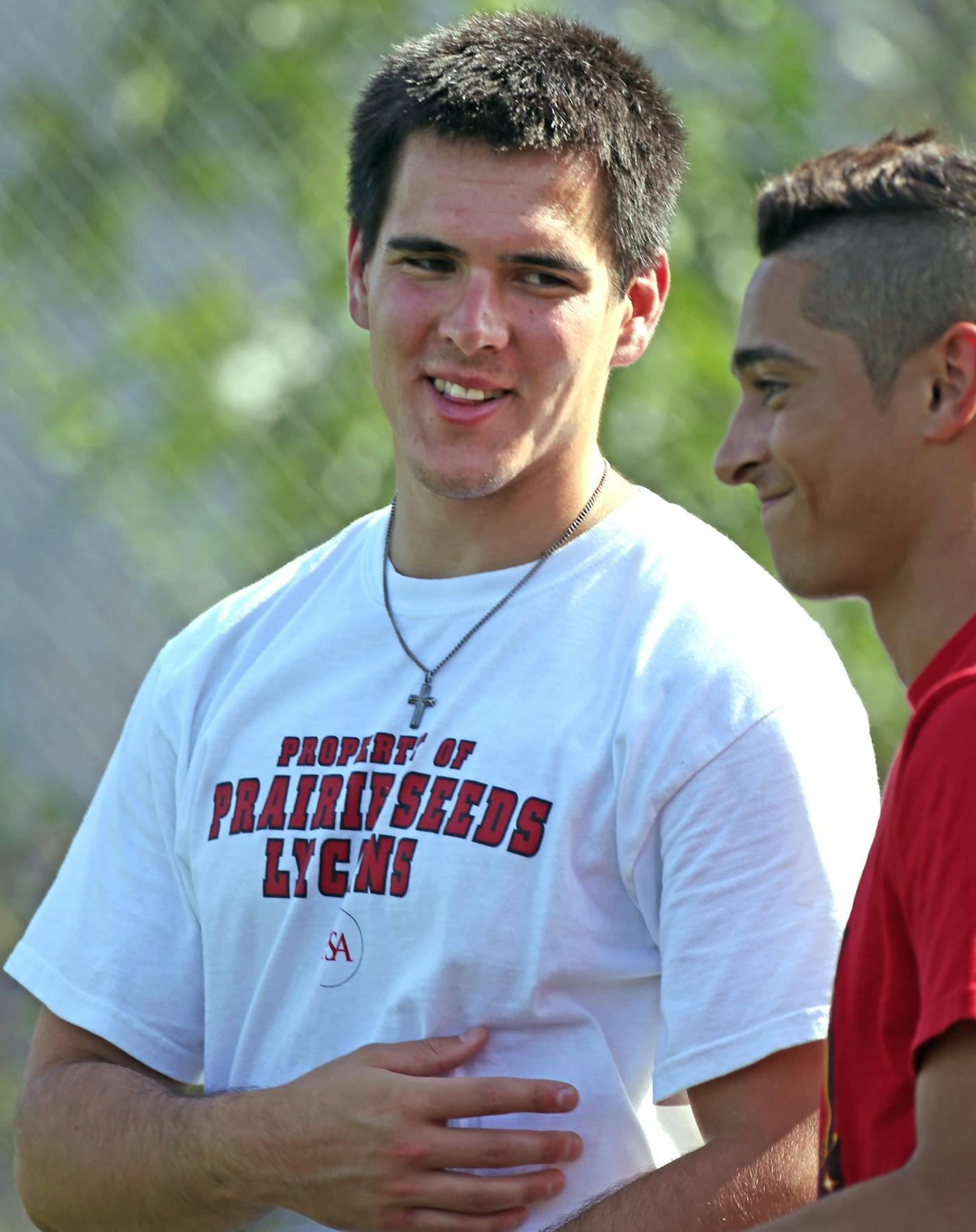 New Prairie Seeds Academy athletic director Jason Obarski talked with Lycans player Mounir Peterson-Darbaki before practice.