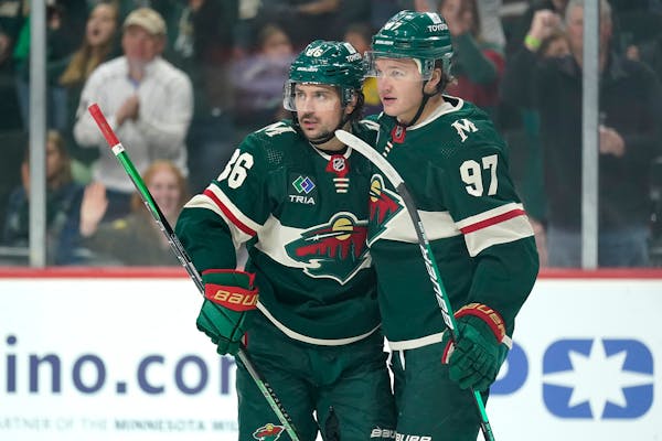 Wild left wing Kirill Kaprizov celebrates with right wing Mats Zuccarello after scoring a goal against the Dallas Stars during the first period of a p