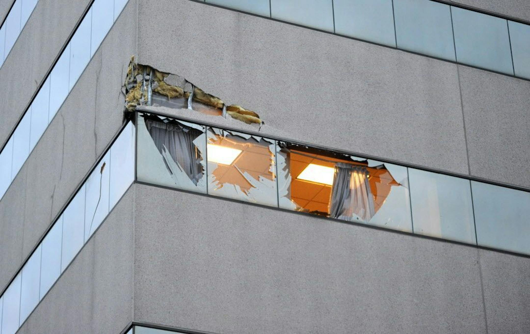 This Dec. 29, 2015 photo shows damage to the corner of The Brady Building after a small plane crashed into it in downtown Anchorage, Alaska. The pilot was not authorized to fly the aircraft used in volunteer search-and-rescue missions, authorities said.
