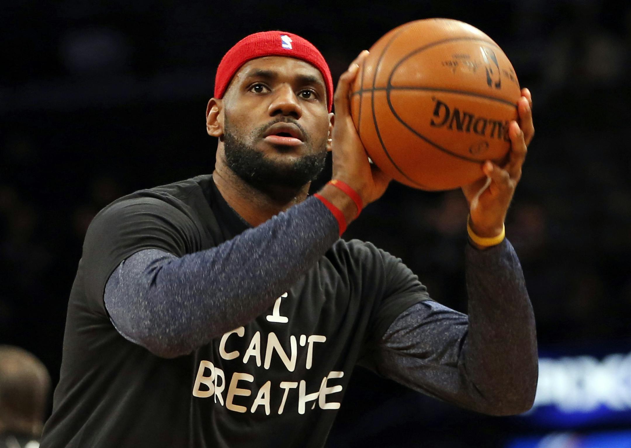 FILE - In this Dec. 8, 2014, file photo, Cleveland Cavaliers forward LeBron James, wearing an "I Can't Breathe" shirt, warms up before an NBA basketball game against the Brooklyn Nets at the Barclays Center in New York. A social activist most of his adult life, Cleveland Browns Hall of Fame running back Jim Brown has been encouraged to see athletes make powerful societal statements and voice their opinions in the wake of recent protests around the country. (AP Photo/Kathy Willens, File)