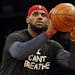 FILE - In this Dec. 8, 2014, file photo, Cleveland Cavaliers forward LeBron James, wearing an "I Can't Breathe" shirt, warms up before an NBA basketba
