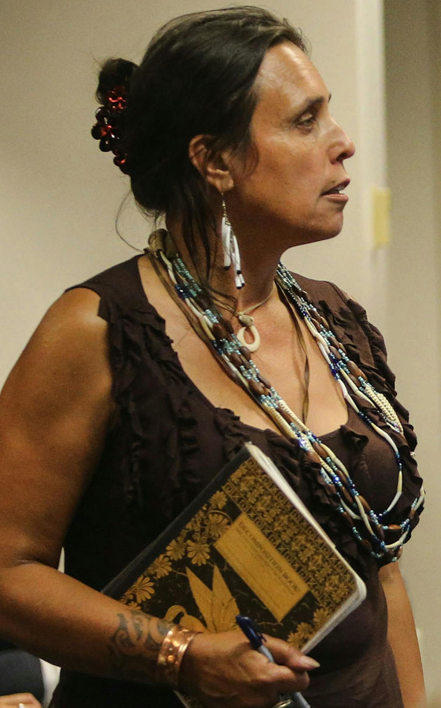 The Minnesota Public Utilities Commission met to consider alternative routes on the proposed Sandpiper pipeline across northern Minnesota to carry Bakken oilThursday, Aug. 7, 2014, in St. Paul. Here, Winona LaDuke, center, an Anishinaabe environmentalist and activist, gets up to introduce herself and let commissioners know she will be speaking later on.] (DAVID JOLES/STARTRIBUNE) djoles@startribune The Minnesota Public Utilities Commission met to consider alternative routes to for the Sandpiper