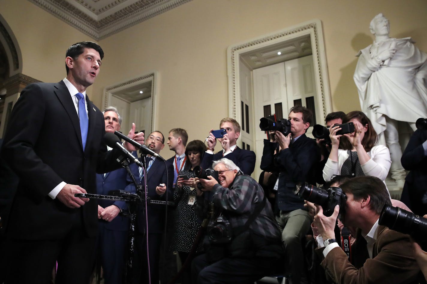 House Speaker Paul Ryan of Wis., left, speaks during a news conference after the House voted to approve the Republican tax bill, Tuesday, Dec. 19, 2017, on Capitol Hill in Washington. (AP Photo/Jacquelyn Martin)